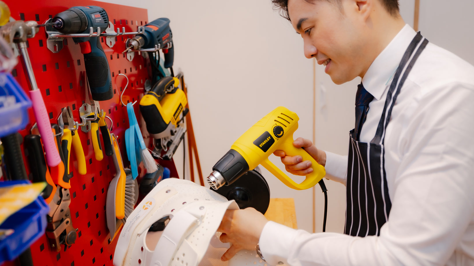 A ScolioAlign brace being shaped by hand in the clinic workshop